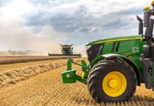 Diesel Crunch Triggers $8B Shock A green tractor in a wheat field.