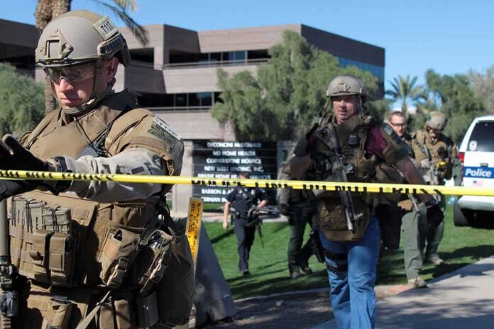 shutterstock_1421710592 Tactical police officers behind yellow caution tape at an outdoor scene