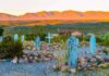 Two Missing Men Found in Shallow Desert Graves Desert cemetery with weathered blue wooden grave markers at sunset