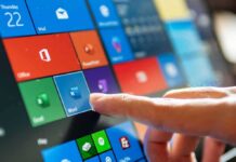 Finger tapping a tablet screen with colorful app tiles