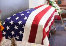 Death Data Failure Fuels Brazen Benefit Grab American flag-draped casket at a funeral service