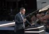 Peter Thiel speaking at a podium with microphones