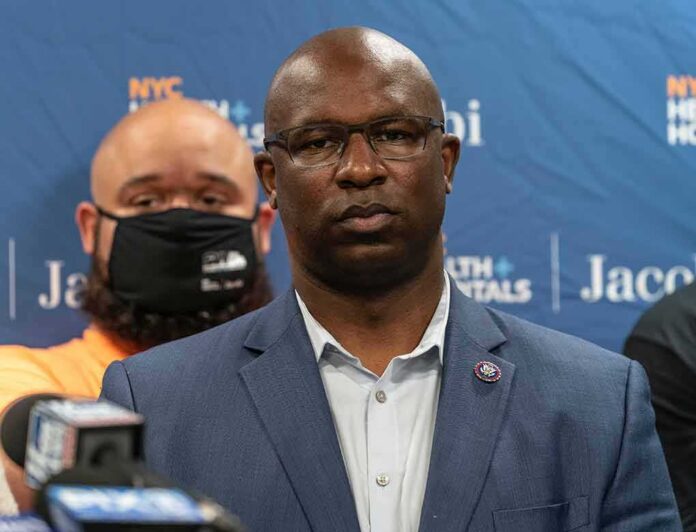 shutterstock_1985256113 Man in suit and glasses at a press conference