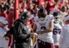 Trainer Swat Sparks Suspension Demands Mississippi State football coach and quarterback review play card on sideline
