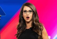 Workplace Bombshell: Card Details Paired With Nudes Woman with glasses speaking on stage with colorful backdrop
