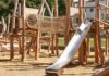Playground Accident Leaves 13-Year-Old Dead wooden playground with rope tunnel and metal slide