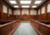 Pregnancy Attack Claim – Hill Denies, Jury Waits Empty courtroom with wooden benches and judge's bench