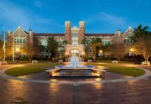 Homecoming Horror: Packed Deck Gives Way Historic brick university building with central fountain at dusk
