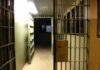 Prison corridor with open barred cell doors