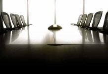 empty conference room with long table and chairs